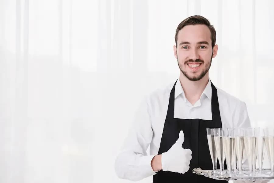 Professional hospitality staff delivering guest service